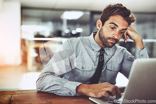 Image of Business man, laptop and bored in office with thinking, glitch or tired with stress, anxiety and problem. Businessman, computer and exhausted at desk with fatigue, burnout and 404 error on internet