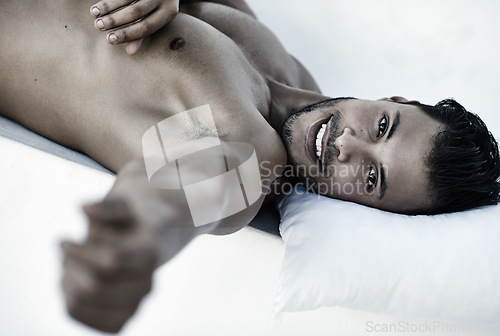 Image of Rest, portrait of happy man on bed and head on pillow in bedroom for comfort at his home. Shirtless or topless person, confidence and smiling or strong male model relaxing in a white background.