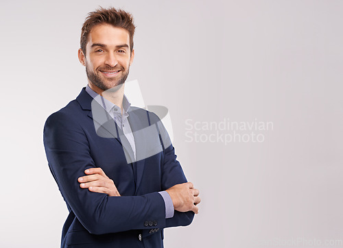 Image of Portrait of confident business man, arms crossed in a suit with smile isolated on studio background. Professional mindset, career success and mockup space with corporate male employee and pride