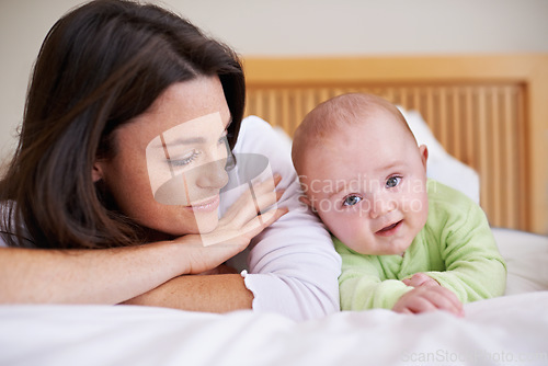 Image of Mother, happy baby and relax bed for love, care and fun quality time together at home. Mom, cute newborn child and bonding in bedroom for support, happiness and joy for healthy development of infant