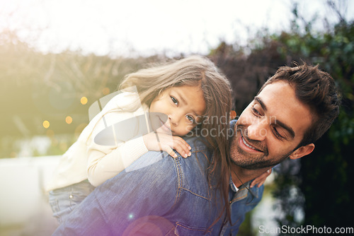 Image of Happy, piggyback and playful with father and daughter in nature for bonding, family and affectionate. Smile, relax and happiness with man carrying young child in park for support, weekend and care