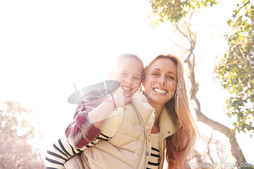 Image of Love, portrait and mother and child piggyback in a park, bond and having fun outdoor. Happy, face and parent with girl in nature hug, smile and enjoying vacation, weekend or holiday in a forest