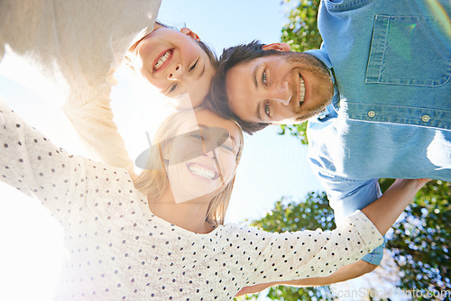 Image of Face portrait, outdoor circle and happy family hug, love and solidarity of kid, mom and dad bonding in park, forest or woods. Nature freedom, sky and below view of people smile for natural sunshine