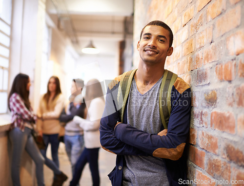 Image of University, education and portrait of man with crossed arms ready for college, class and learning. Scholarship, happy and face of male student in hallway with friends for school, academy and campus