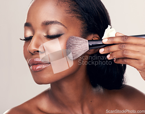 Image of Beauty, makeup and black woman with brush on face in studio and cosmetic application tool. Skincare, blush and cosmetics, facial skin care model with happiness and luxury shine on white background.