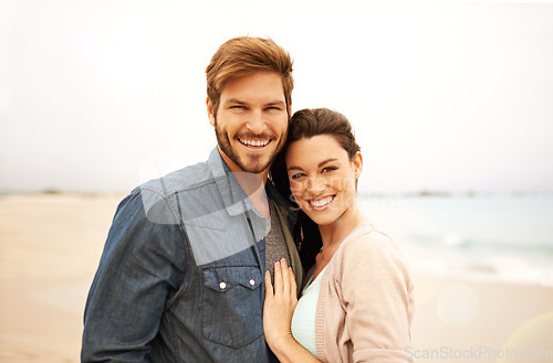 Image of Couple, portrait and embrace at beach for travel, romance and freedom together outdoors. Face, smile and happy woman hugging man on trip, vacation or holiday, bond or having fun standing in Bali
