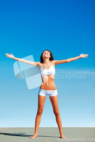 Image of Freedom, fitness woman and healthy body outdoor with happiness and underwear ready for exercise. Blue sky, workout and female person with happy smile and liberation from sun and nature with wellness