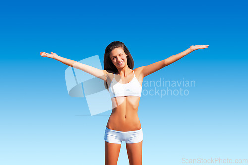 Image of Freedom, woman portrait and healthy body outdoor with happiness and relax ready for fitness. Blue sky, young and female person with a happy smile in summer sun and nature with wellness and carefree