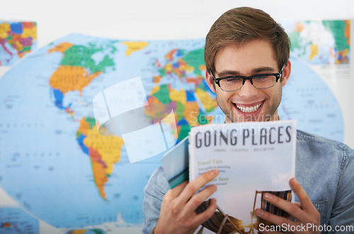 Image of Travel agency, magazine and happy man reading brochure information, tourism book or research world tour ideas. Business, agent and professional person, client or customer smile for destination plan