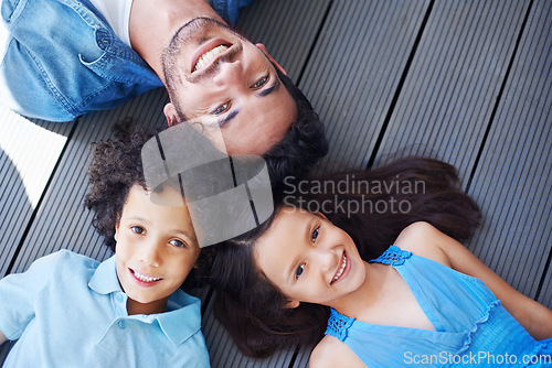 Image of Floor portrait, relax and happy kids, father or family bonding together, smile and happiness for youth growth. Love, face and top view of solidarity children, dad or group of people lying on ground