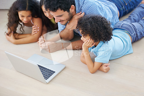 Image of Laptop, lying on floor and father and kids watching social media video, online website or family movies. Youth happiness, bonding and family children and dad watch home broadcast film in living room