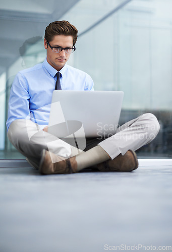 Image of Laptop, office floor and business man typing financial report, statistics analysis or search online, internet or website. Research, company workplace and male businessman, banker or person working