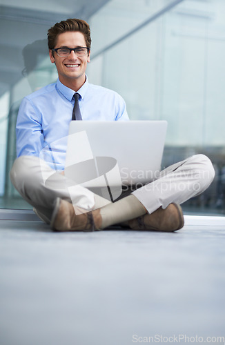 Image of Laptop, office floor and portrait of happy man, agent or professional consultant typing report, project or email. Research, company workplace and male businessman, banker or person sitting on ground