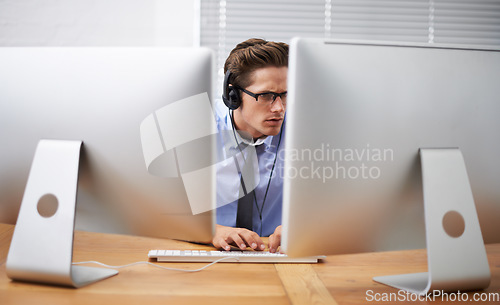 Image of Computer, office focus and business man typing, reading or working project, research report or statistics analysis. Information technology, cybersecurity and person listening to music while coding
