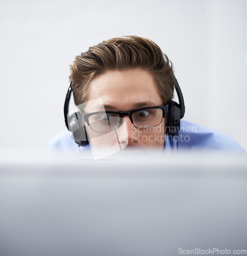 Image of Office computer, face and man reading script, software code or problem solving cyber security system. Information technology, cybersecurity developer or closeup person listening to music while coding