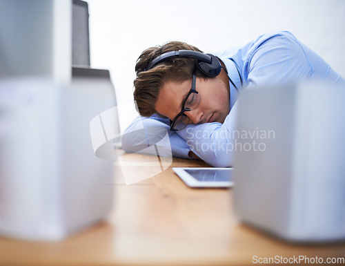 Image of Office desk, sleep and business man tired after working on project, software system or coding tech, script or programming. Programmer burnout, developer fatigue and sleeping person listening to music