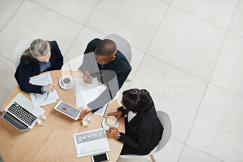 Image of Top view, staff and employees brainstorming, collaboration and planning with technology, documents and discussion. Business people, group and coworkers share ideas, website launch and online reading