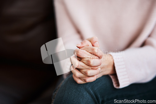Image of Woman, hands together and grief closeup with stress and anxiety in therapy for psychology crisis. Pray, mental health problem and hand of a female patient scared with depression at counseling on sofa