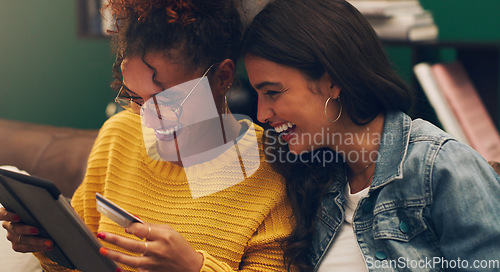 Image of Girl friends, laugh and credit card with tablet on a living room sofa with online shopping. Student, happiness and young woman together with web purchase and ecommerce payment app on a home lounge