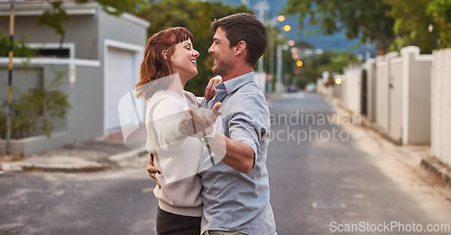 Image of Dance, street and a happy couple having fun together outdoor while bonding in their domestic neighborhood. Love, road or residential with a man and woman bonding while dancing outside for freedom