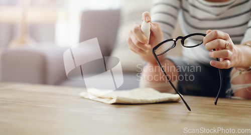 Image of Hands, woman cleaning glasses and spray bottle with chemical liquid, cloth and hygiene with lens maintenance. Clean spectacles, eyewear and female cleaner at home with eye care and mockup space