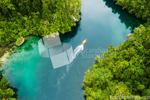 Image of Island, ocean and drone view of a boat in nature with trees for sailing on vacation or weekend trip. Travel, adventure and aerial view of speedboat on sea of tropical resort water for summer holiday.