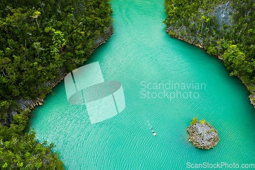 Image of Travel, aerial and man swimming on island for adventure, holiday and summer vacation in Mauritius. Nature, seascape and drone view of person in tropical water, destination and traveling on islands