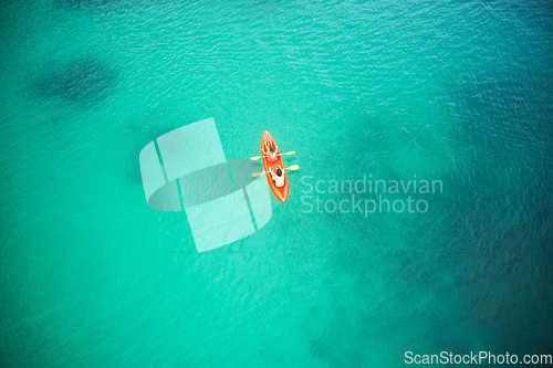 Image of Top view, boat and people in blue ocean together for kayak adventure, travel or journey at sea on mockup. Couple trailing or rowing on big calm, peaceful or serene beach water in nature for kayaking