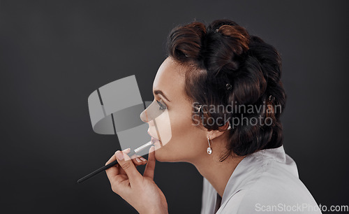 Image of Beauty, lip liner and woman with cosmetics application, natural skincare glow or facial makeup. Wellness, profile and studio person with skin treatment, dermatology or prepare on black background