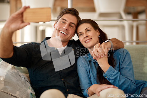 Image of Couple, couch and selfie in home for smile, holding hands or pride for love, care or internet app. Man, woman and happy for photography, profile picture or social media for bond, relax or lounge sofa