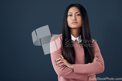 Image of Confident, portrait of Korean woman and in a studio background with her arms crossed. Empowerment or elegant, corporate worker and pose with serious or proud young businesswoman in a backdrop.