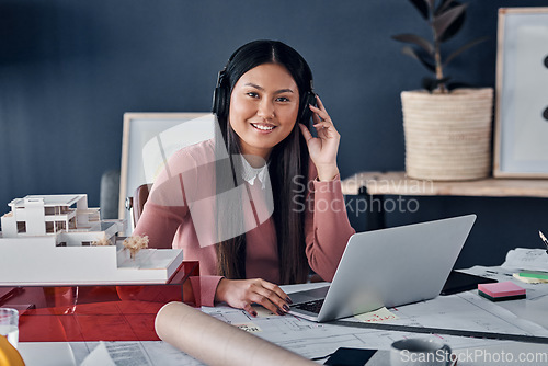 Image of Headphones, laptop and portrait of architect woman in office streaming radio podcast. Face, music and Asian female designer listening to audio, sound or happy song, web browsing or social media on pc