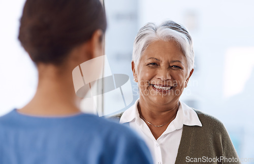 Image of Healthcare, happy or nurse talking to an old woman about treatment in a nursing home facility clinic. Elderly face, smile or female medical worker speaking to a senior patient in a hospital visit