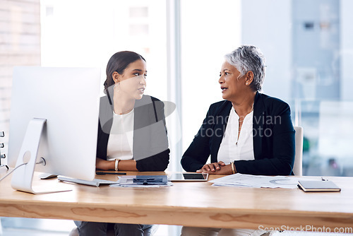 Image of Mentor, collaboration or business women with computer talking, speaking or planning a project in office. Technology, teamwork or senior manager with female intern for strategy training or coaching