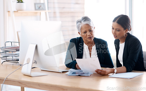 Image of Mentor, coaching or business women with paperwork talking, speaking or planning project in office. Documents, teamwork collaboration or senior manager reading with intern for administration training