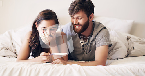 Image of Couple, bedroom and pregnancy test, happy and excited for future family, life, love and happiness together. Positive results, man with pregnant woman on bed with good news, surprise and shock in home