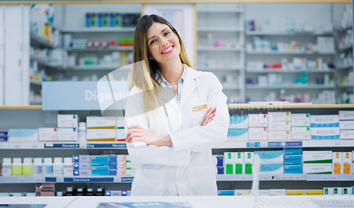 Image of Pharmacy portrait, arms crossed and happy woman, pharmacist or manager in drugs store, dispensary or shop. Hospital dispensary, medicine product shelf and person confident in retail clinic service