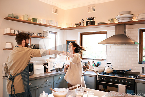 Image of Excited young couple, dance and kitchen in home with love, comic moment and cooking together with romance. Man, woman and smile with dancing, moving and happiness for food, nutrition or diet in house