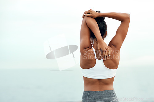 Image of Woman, back stretching and outdoor for yoga, workout and training with mockup space. Wellness, nature and ocean with female person doing exercise for health and relax by the sea with stretch arms