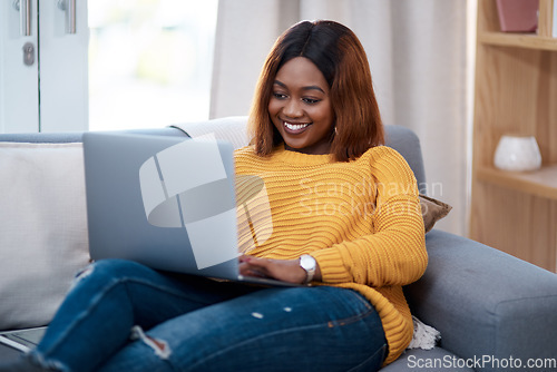 Image of Black woman with laptop, smile and relax on couch, search online for movie and streaming subscription at home. Happy African female person in apartment, connectivity and watching on pc with internet