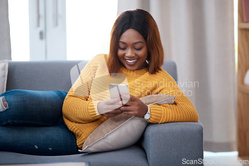 Image of Black woman with smartphone, chat on social media and relax at home, smile with online communication. African female person, mobile app with text message or post update with connectivity in apartment