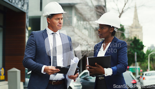 Image of Architecture, planning and talking people in the city for construction, design and ideas on a tablet. Building, documents and a black woman and man in development speaking about infrastructure ideas