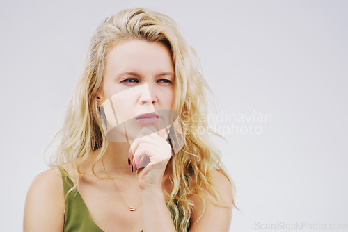 Image of Young woman, thinking and confused in studio with ideas, memory and focus by gray background. Girl, model and think with concentration, remember and decision for choice, planning or question on mind