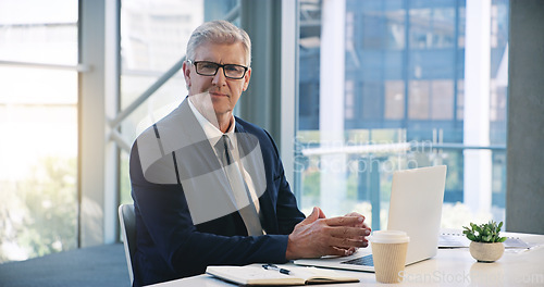 Image of Mature businessman, portrait and in an office with a laptop for communication and connectivity. Corporate, company and a manager or boss of an agency with a pc for networking and internet at work