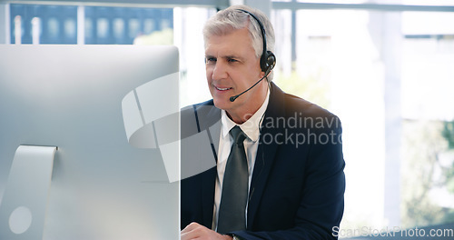 Image of Video call, computer and a mature business man using a headset in the office during an online meeting. Desktop, smile communication with a senior male manager or CEO in an online training webinar