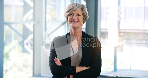 Image of Business woman, portrait and smile in an office with arms crossed for pride of executive career. Face of a senior female entrepreneur happy about corporate growth, goals and motivation at company