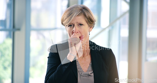 Image of Portrait, infection and a business woman coughing in her office at work while looking sick with a virus. Health, covid and cough with a senior female manager or CEO standing alone in the workplace