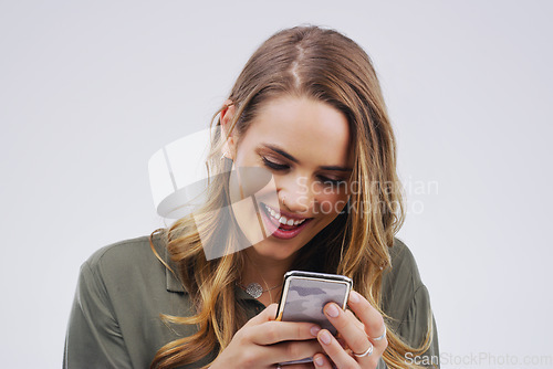 Image of Phone, laugh and face of woman in studio with smile for social media, internet and online meme. Communication, white background and female person on smartphone for funny website, mobile app and humor