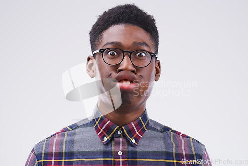 Image of Funny face, comic and portrait of a black man being crazy isolated on a white background in a studio. Geek, mouth movement and face headshot of an African person with glasses as a nerd and goofy