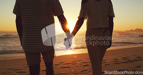 Image of Couple holding hands, beach at sunset and ocean with back view, vacation and travel with man and woman outdoor. Love, romance and trust with people in commitment, tropical holiday and sea waves